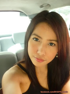 Young woman posing in a car interior.